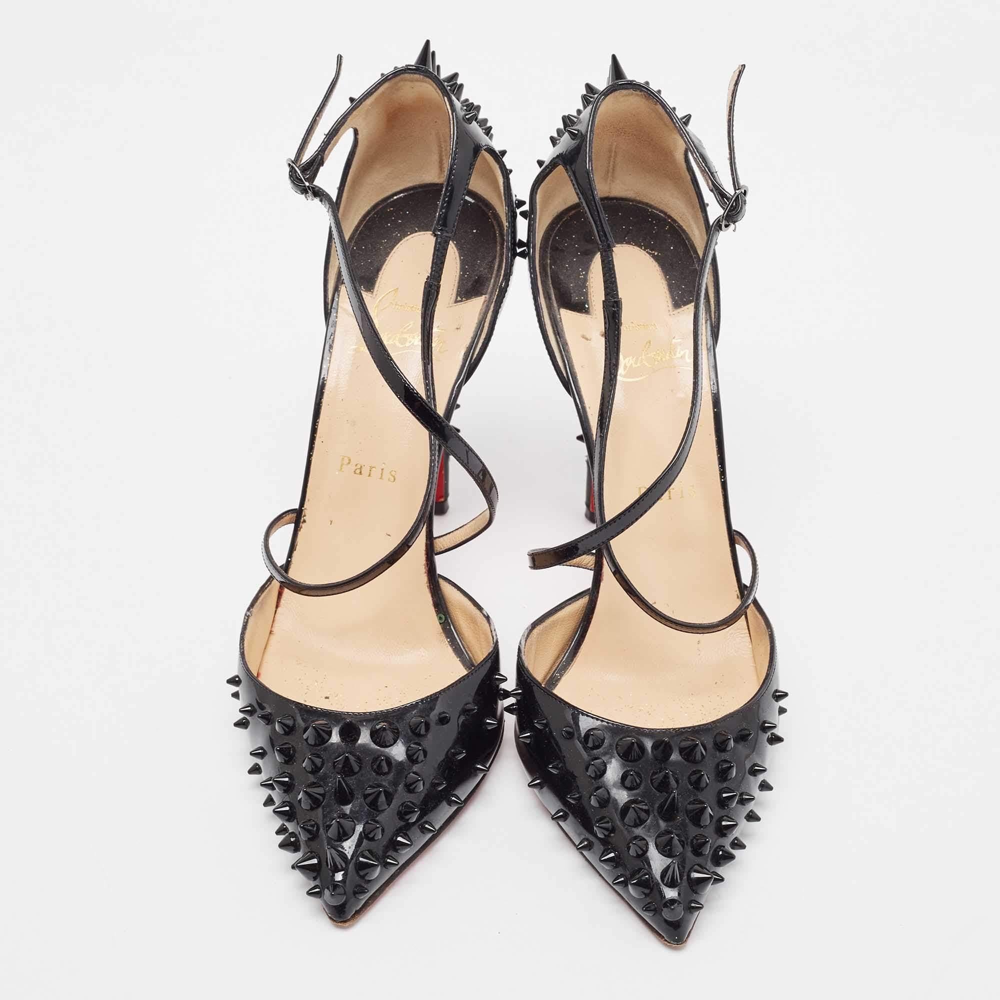 Rock these Christian Louboutin spike pumps at the next party! They have been crafted from patent leather into a criss-cross, ankle strap design and come with comfortable insoles. Gorgeously studded with unique spikes, you can team these bold 11.5 cm