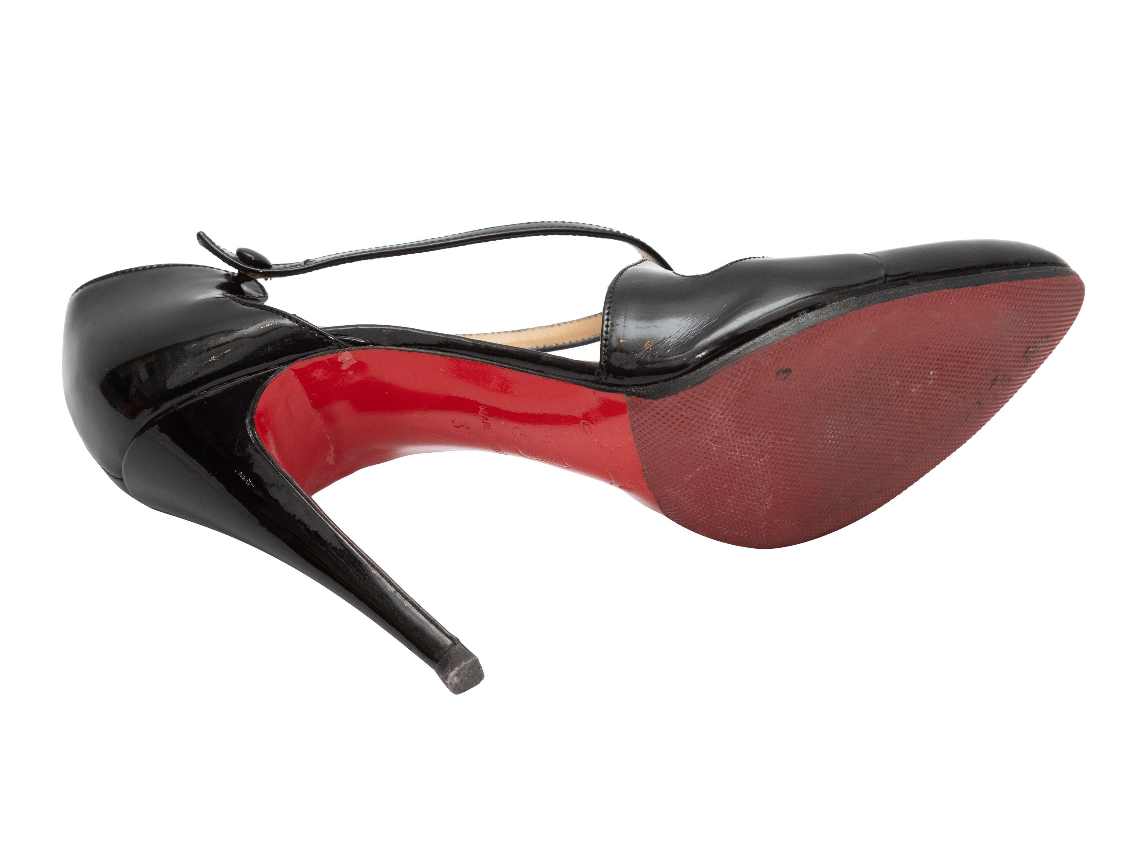 Product Details: Black patent leather criss-cross strap pumps by Christian Louboutin. Button closures at ankle straps. 4