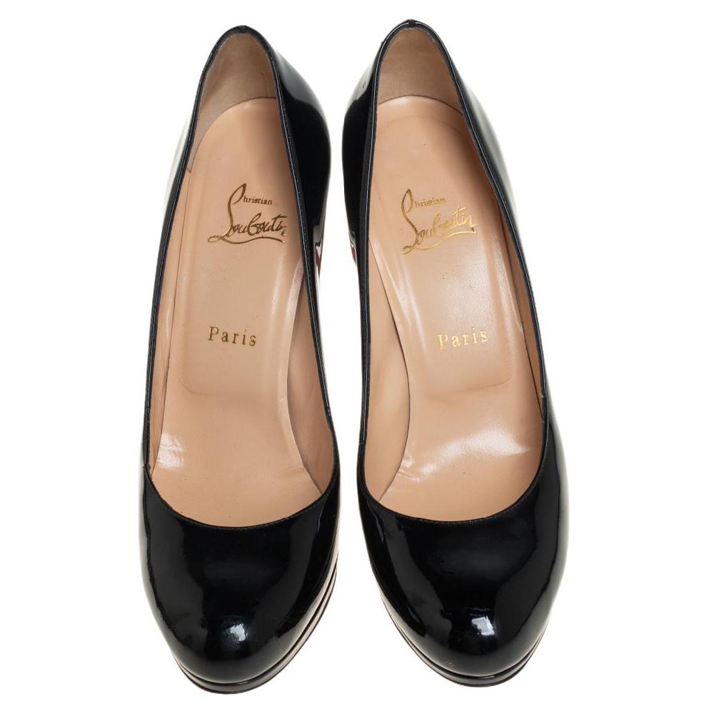 This pair of Christian Louboutin pumps make a modern style statement and is a timeless piece. They have a patent leather exterior, black hue and a classic silhouette. They are finished with round toes and high heels.

