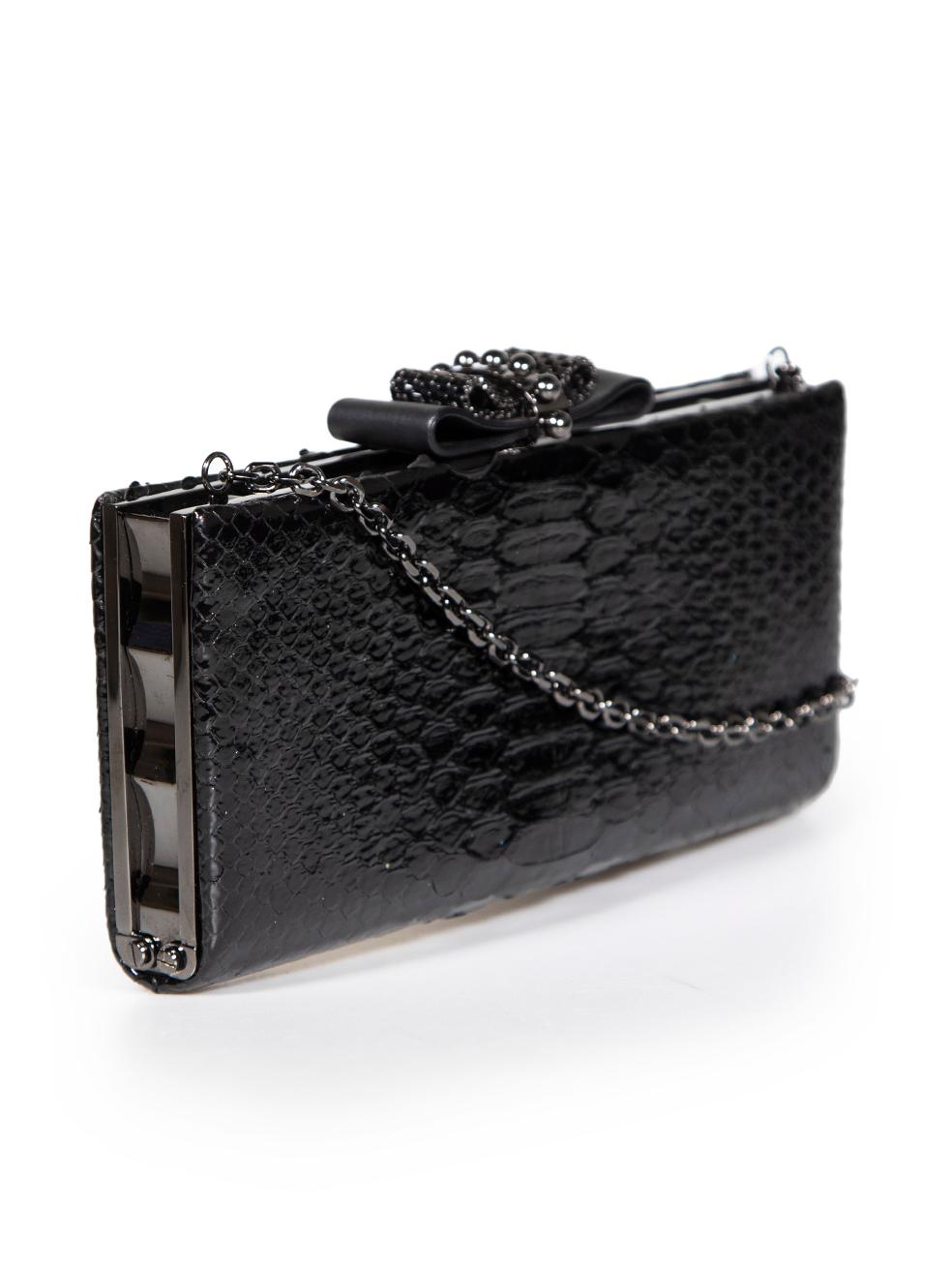 CONDITION is Very good. Minimal wear to clutch is evident. Some of the python leather is peeling at the opening on this used Christian Louboutin designer resale item.
 
 
 
 Details
 
 
 Model: Sweet Charity
 
 Black
 
 Python
 
 Mini clutch bag
 
