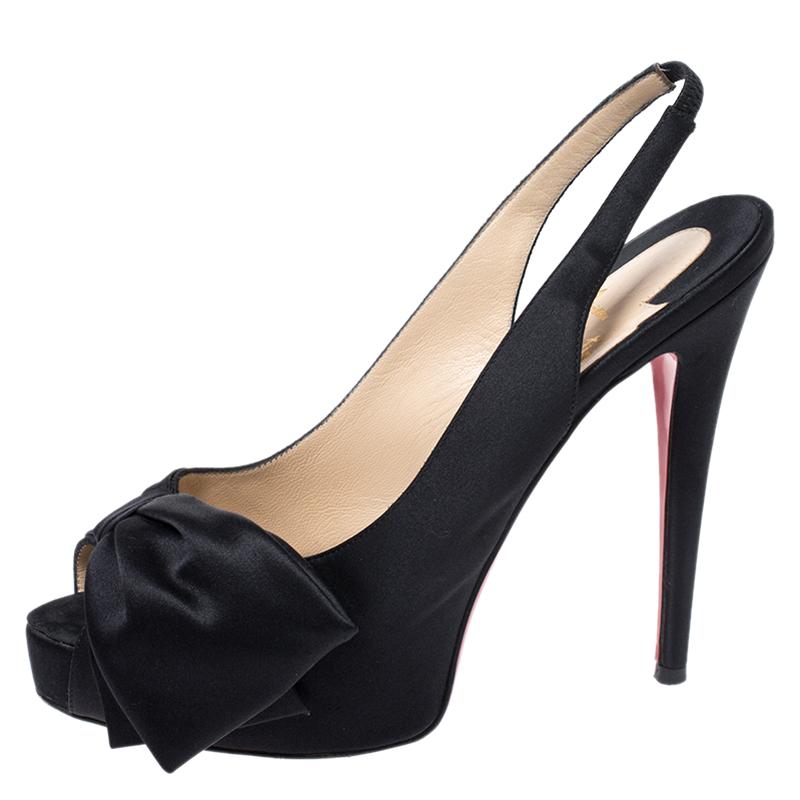 This pair of pumps by Christian Louboutin is a timeless classic. Step out in style while flaunting these amazing satin shoes in black, ideal for special occasions. They feature peep toes decked with a bow accent, slingbacks, platforms and 13.5 cm