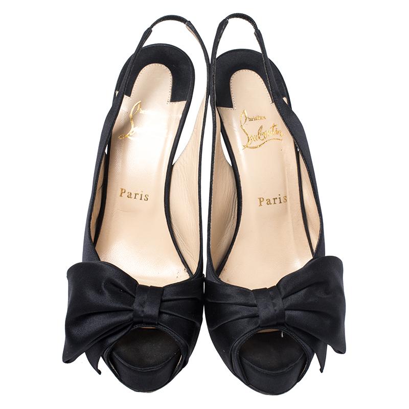 This pair of pumps by Christian Louboutin is a timeless classic. Step out in style while flaunting these amazing satin shoes in black, ideal for special occasions. They feature peep toes decked with a bow accent, slingbacks, platforms and 13.5 cm