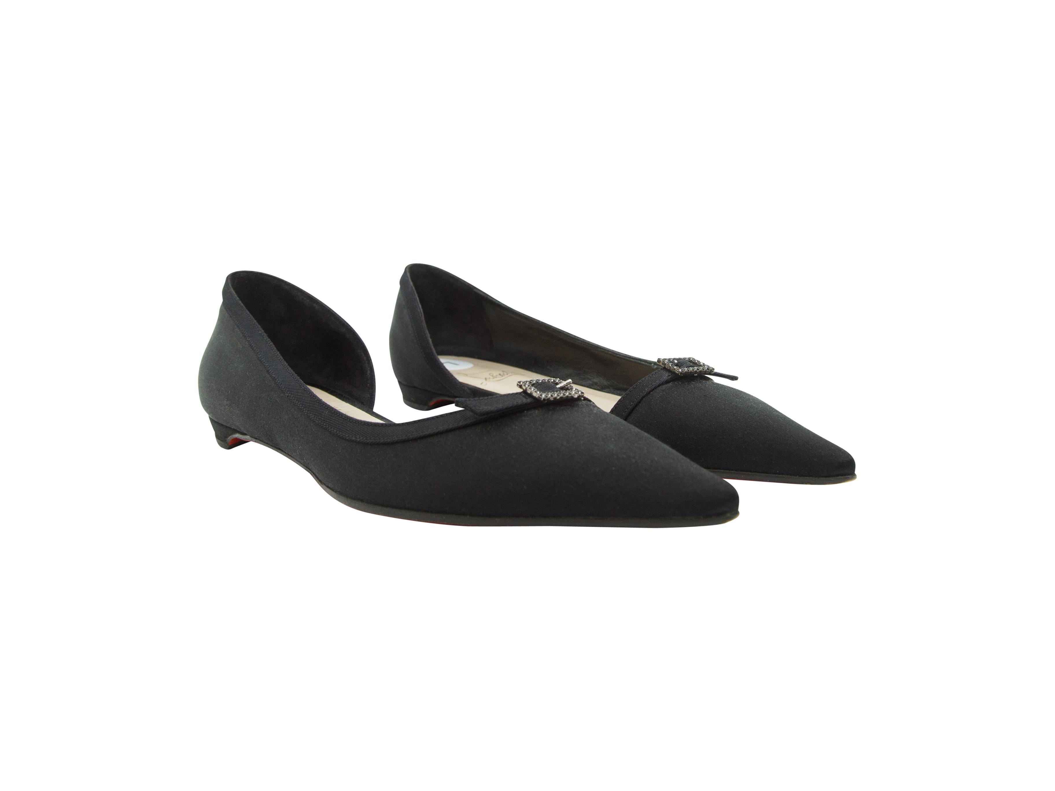 Product details:  Black satin d'Orsay flats by Christian Louboutin.  Crystal-accented buckle trims vamp.  Point toe.  Iconic red sole.  Slip-on style.  
Condition: Pre-owned. Very good.
Est. Retail $ 600.00