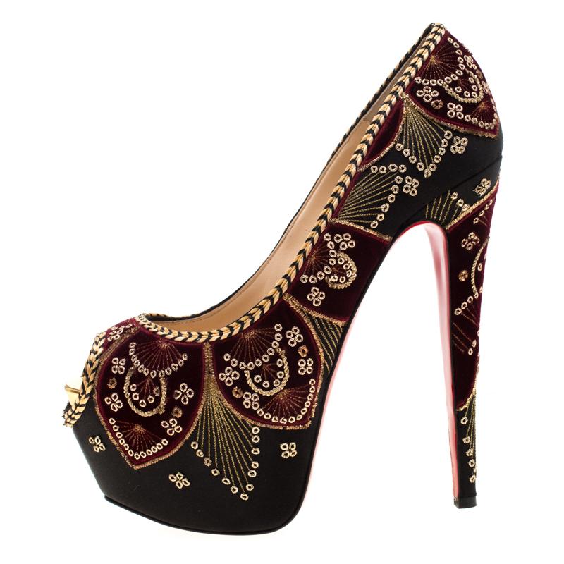 One can only expect such lavish footwear designs from Christian Louboutin as this Highness Sombrero platform pumps. Rendered in black satin, the pair is gloriously beautified with gold-tone embroidery detailed over velvet panels, blending