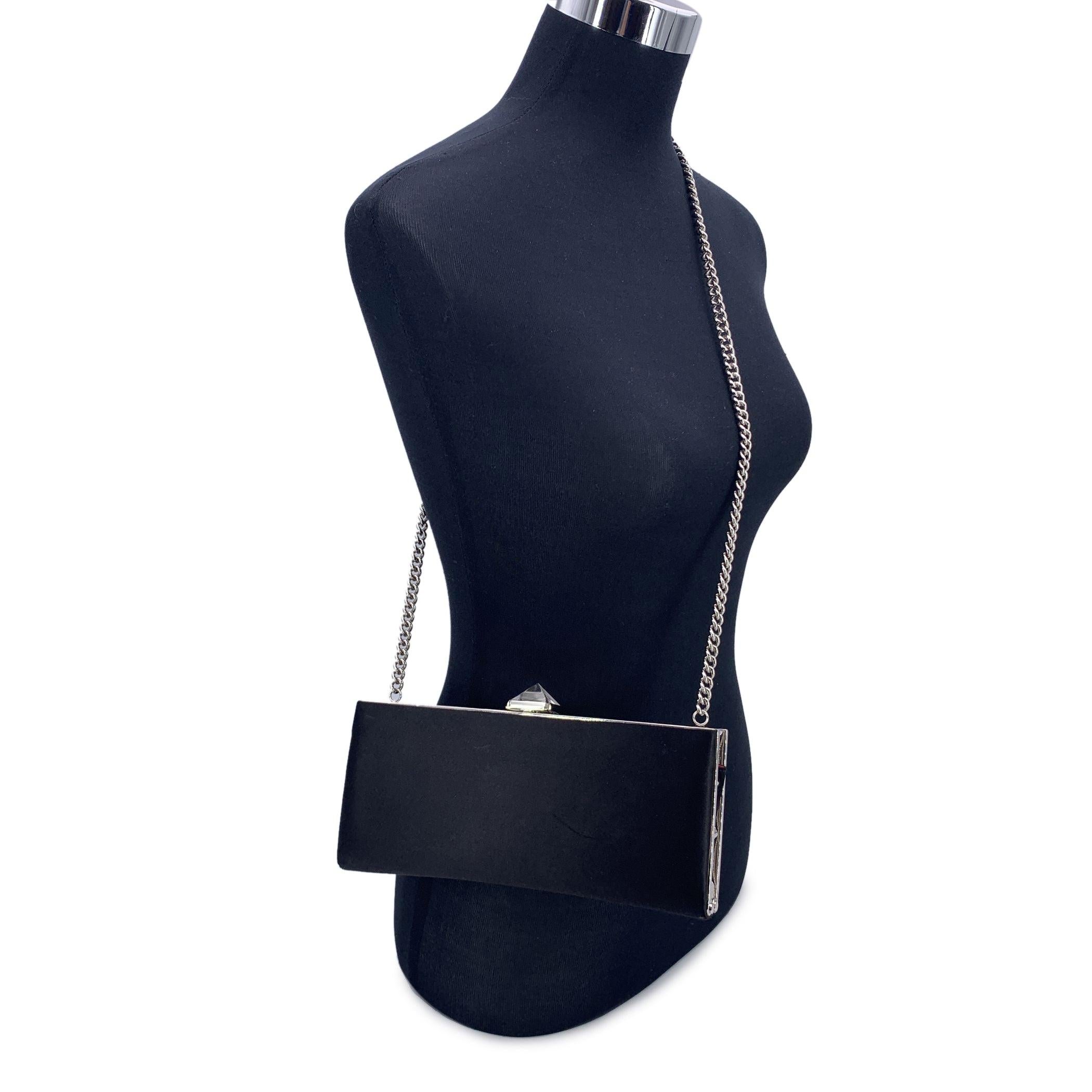 La petite pochette en satin noir Keops de Christian Louboutin est un accessoire de luxe et de sophistication. Elle est à la fois glamour et élégante. Cette exquise pochette présente un luxueux extérieur en satin noir, avec un élégant métal argenté