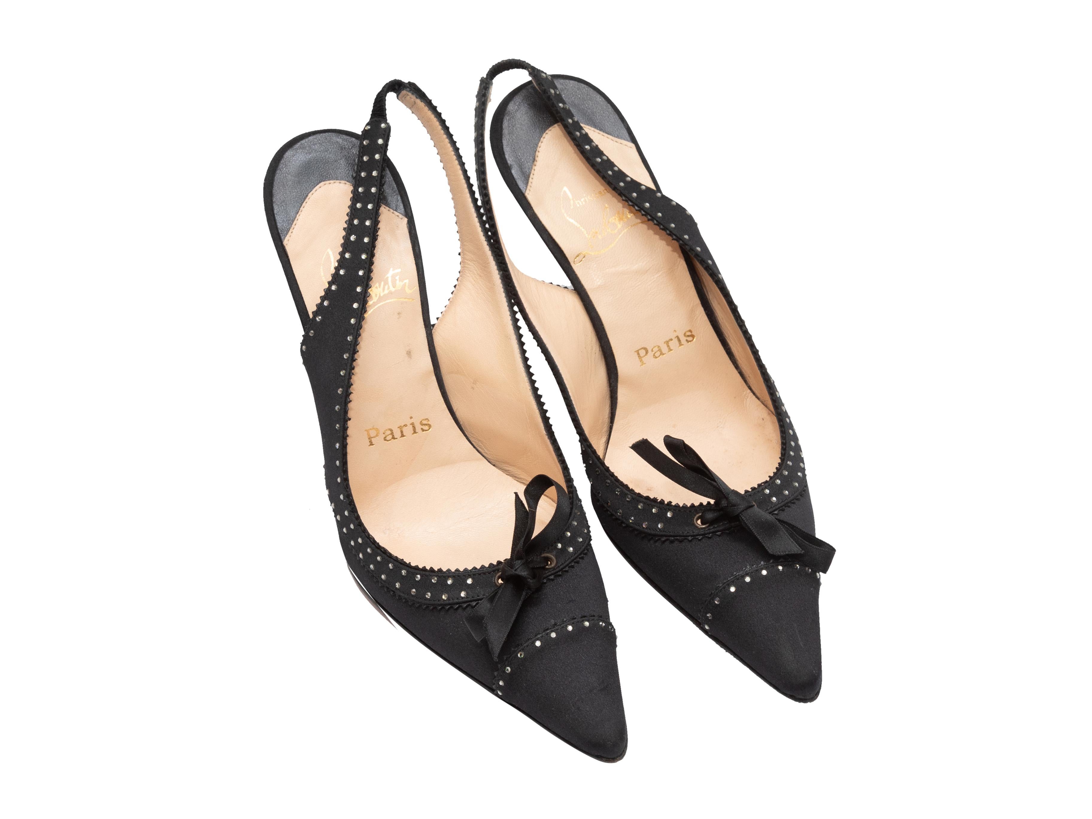 Product Details: Black satin pointed-toe slingbacks by Christian Louboutin. Rhinestone trim throughout. Bow accents at toes. 3.5