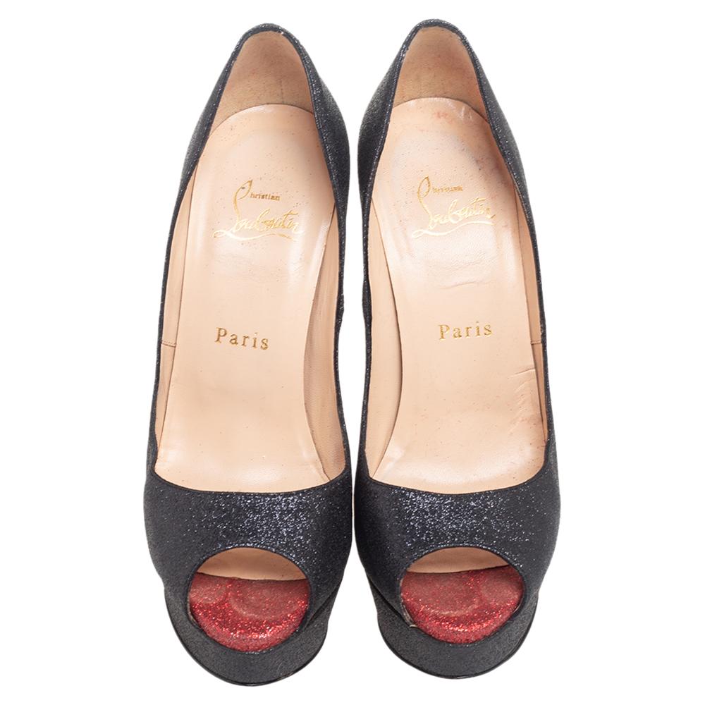 Glamorous and appealing in every detail, these New Very Prive pumps from Christian Louboutin will certainly leave you looking mesmerized and spectacular. They are made from black shimmer fabric and showcase peep-toes, platforms, iconic red soles,