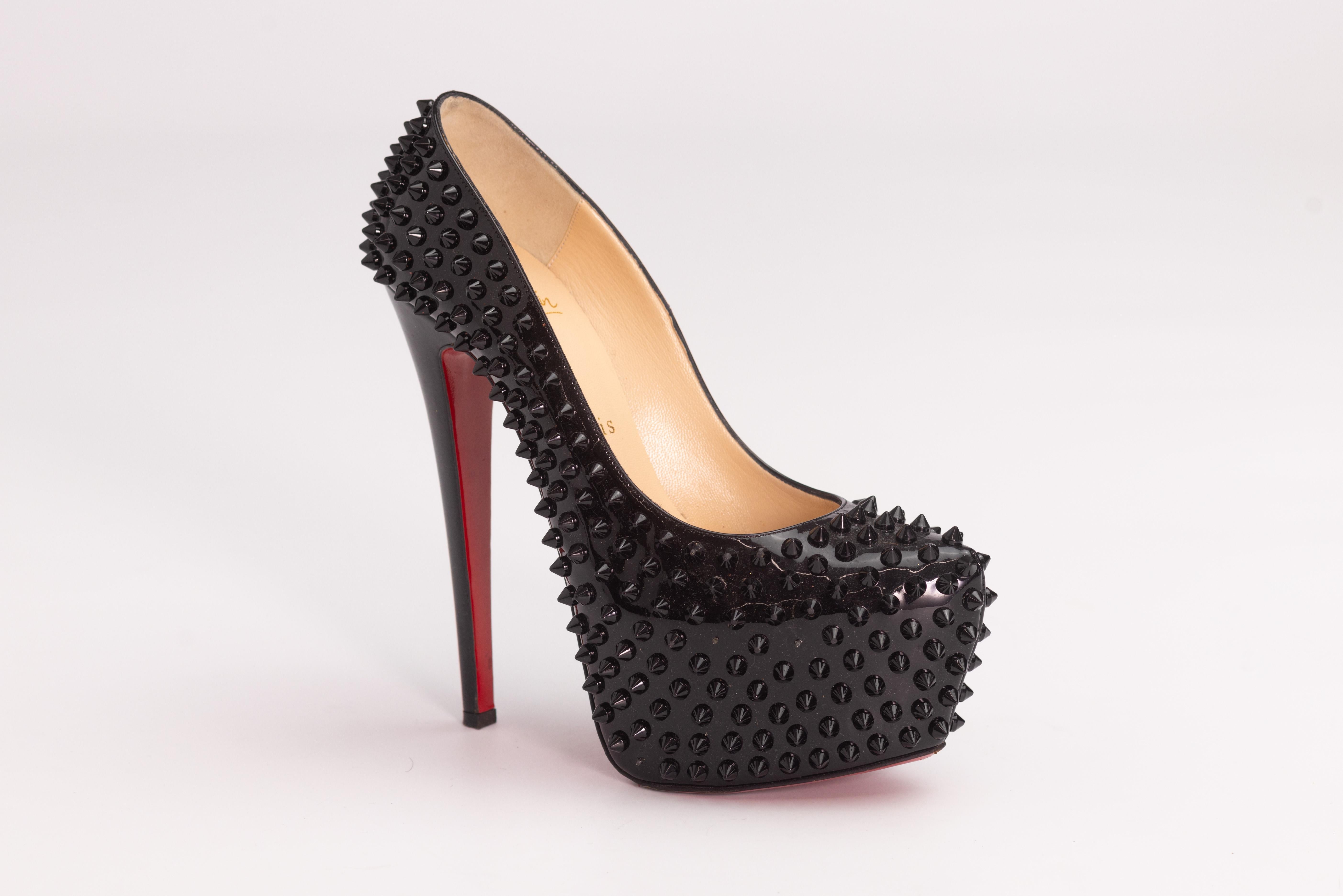 CHRISTIAN LOUBOUTIN BLACK SKIKE PLATFORMS DAFFODILE HEELS (EU 37)

These stunning pumps have a soaring 160mm heel and a 60mm front platform. These sky high heels are composed of black leather with black spikes and signature red lacquered