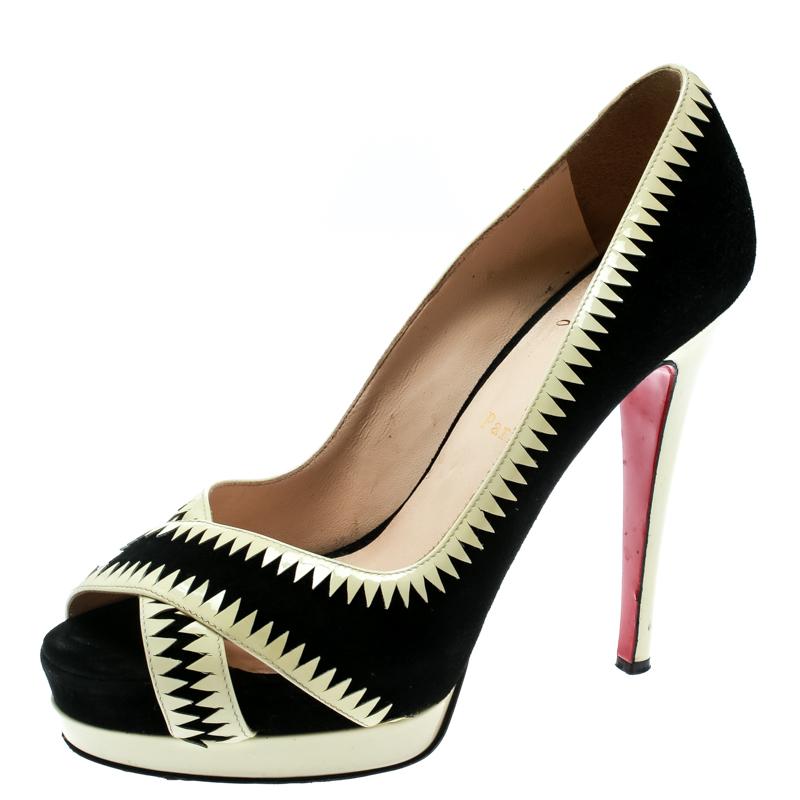 Step out in style and let the crowds go gaga over these gorgeous Louboutin pumps! The black pumps have been crafted from suede and cream patent leather and styled with peep-toes. They flaunt a crisscross design on the vamps and come equipped with