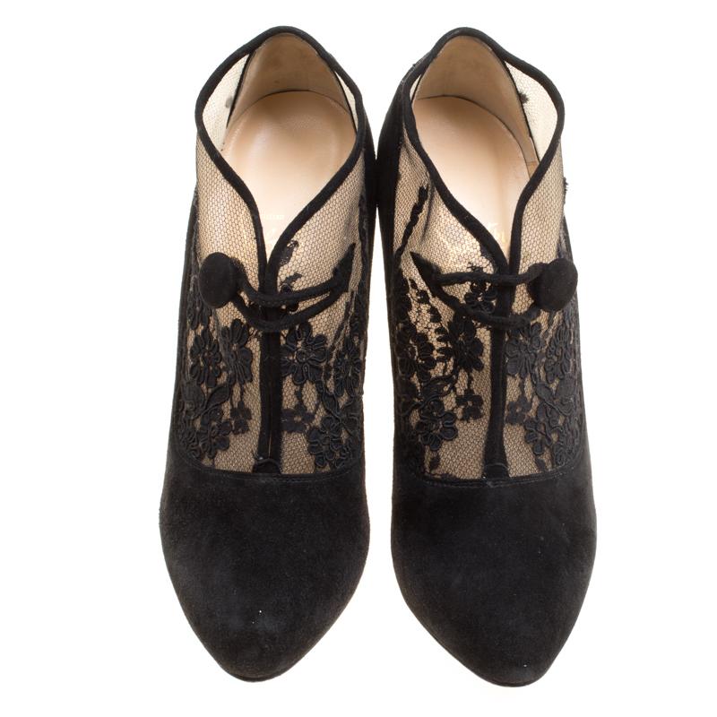 Elegance and feminine grace are what these Christian Louboutin booties are all about! The black Clic Clac booties are crafted from suede, mesh and lace and feature almond toes, beautiful floral lace detailed vamps with a button loop closure and