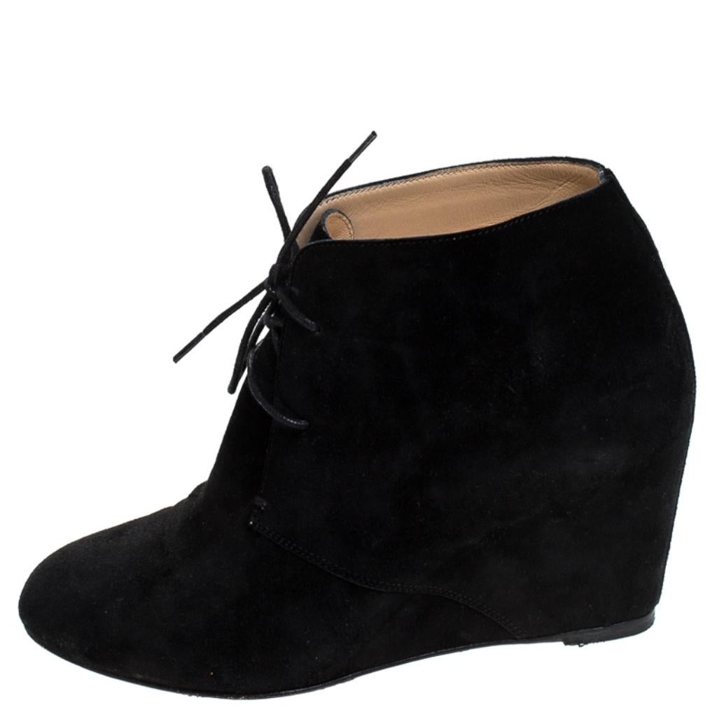 These ankle booties from Christian Louboutin deserve all your attention! Crafted from suede in classic black, they feature round toes and lace-ups on the vamps. They come equipped with comfortable leather-lined insoles and wedge heels. The signature