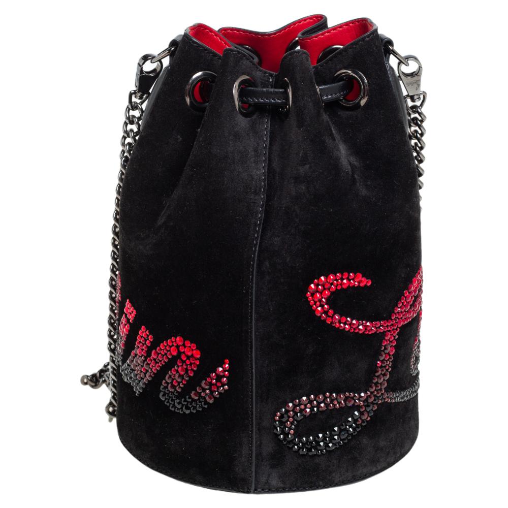 Christian Louboutin gives its Marie Jane bucket bag a dazzling update. This version is made from suede and adorned with scores of shimmering crystals throughout the exterior. It has a sturdy base and an optional chain strap.

Includes: Original