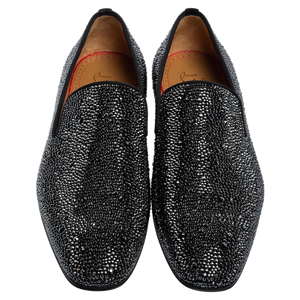 Make a fashionable entrance in these cool slippers from Christian Louboutin. They have been meticulously crafted from suede and have a striking black exterior decorated with strass embellishments all over. This pair is finished with leather insoles