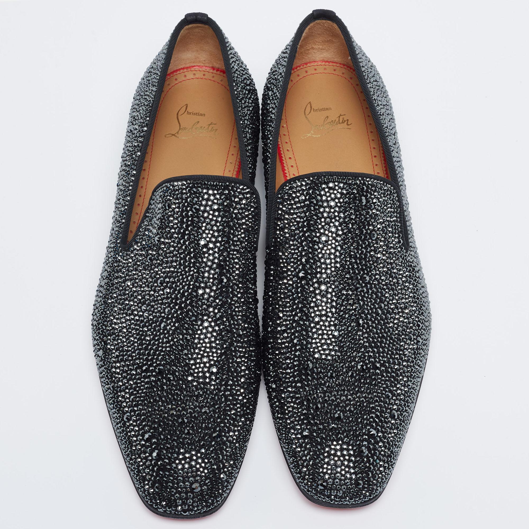 Make a fashionable entrance in these cool slippers from Christian Louboutin. They have been meticulously crafted from suede and have a striking black exterior decorated with strass embellishments all over. This pair is finished with leather insoles