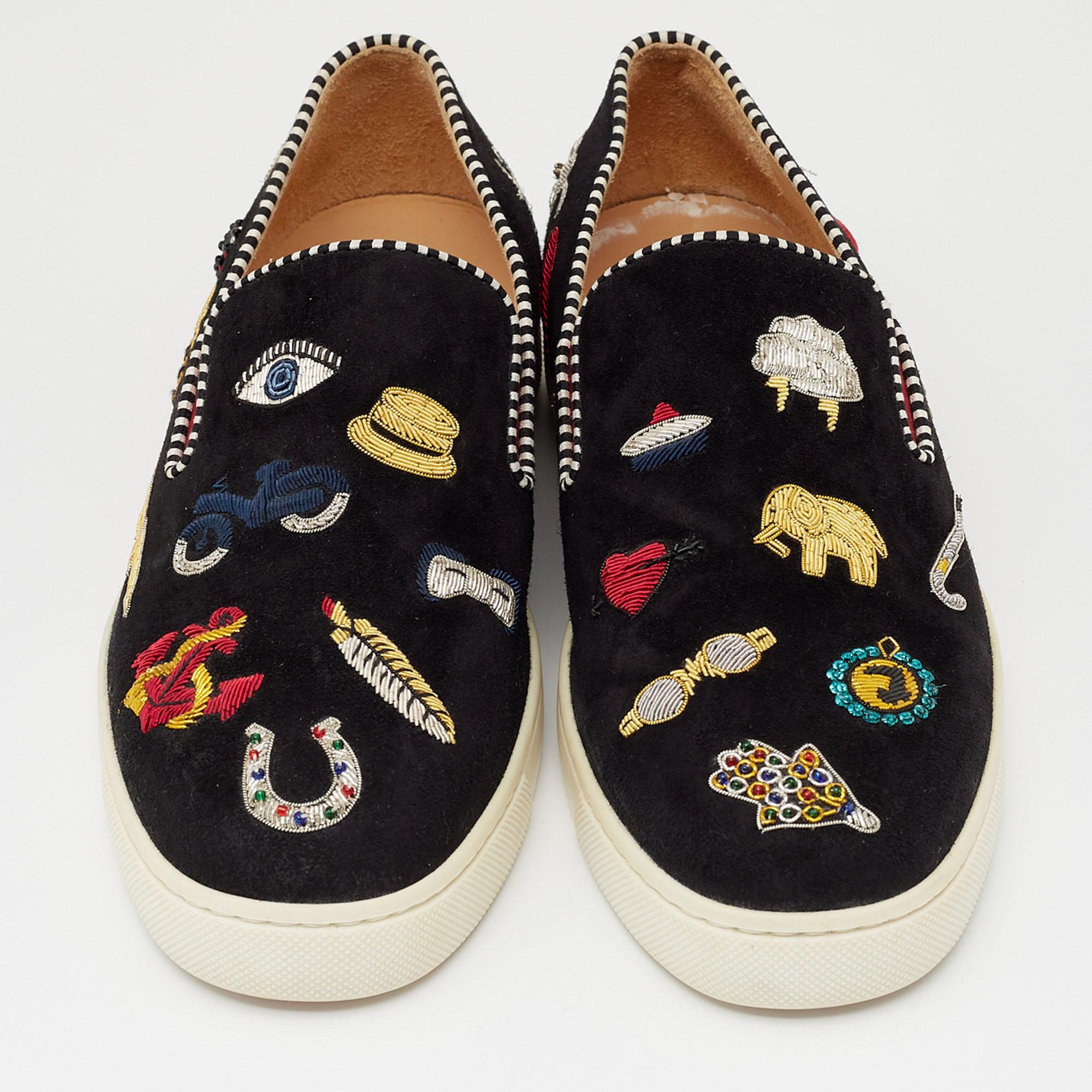 Find complete comfort, panache, and style as you walk in these sneakers from the House of Christian Louboutin. Made from black suede, these sneakers are embellished with multicolored appliques throughout. They flaunt an easy slip-on style and red