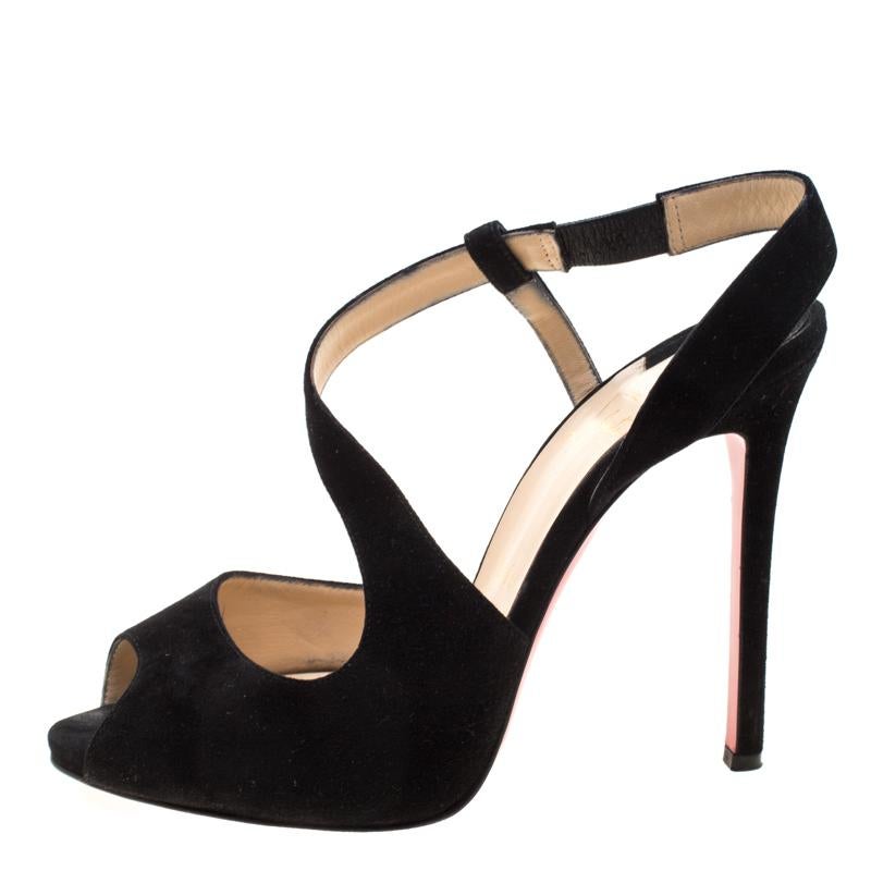This pair of black sandals by Christian Louboutin is lovely. They've been wonderfully made from suede in a design of peep toes, cross straps forming slingbacks, 12 cm heels and the iconic red soles. They will look great on your feet.

Includes: The