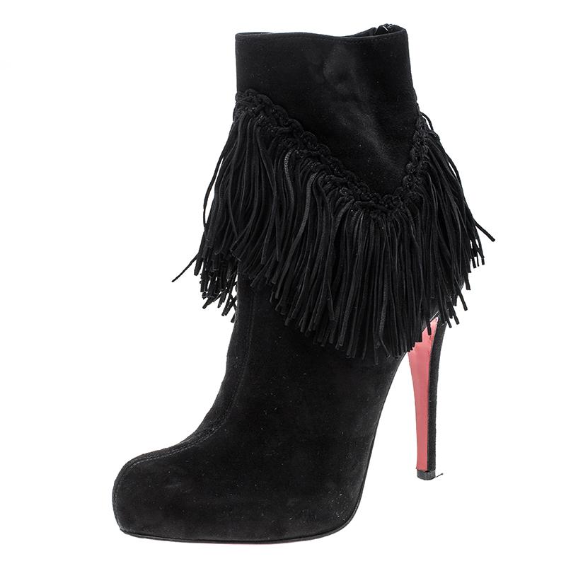 Add an instant touch of glam and fun style to your party looks with these stunning Christian Louboutin Rom platform ankle boots. Constructed in black suede material, these boots are made special with heavy fringe accents all around the ankle which