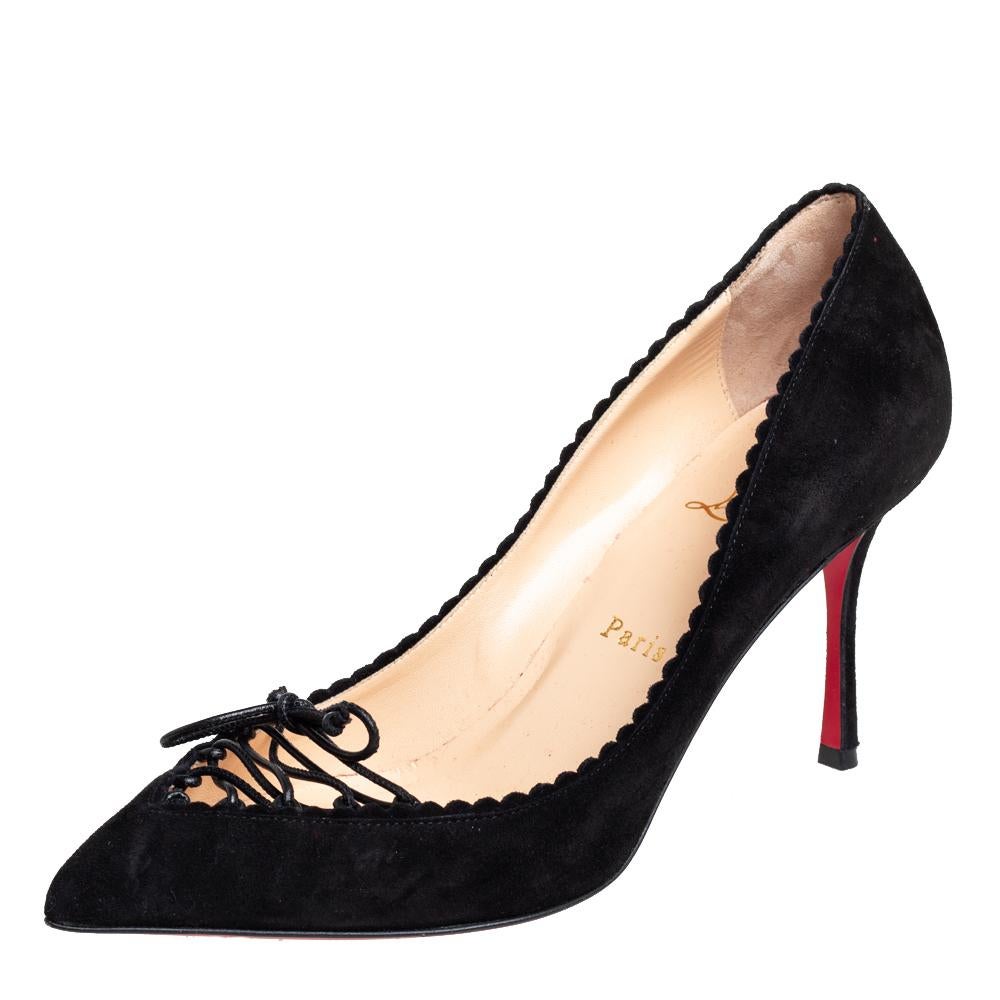 Timeless allure combined with brilliant craftsmanship gives us these beautiful Christian Louboutin Scalo pumps. Crafted from suede in a black shade, they are adorned with ties and scalloped details. These pumps are mounted on 9 cm heels for the