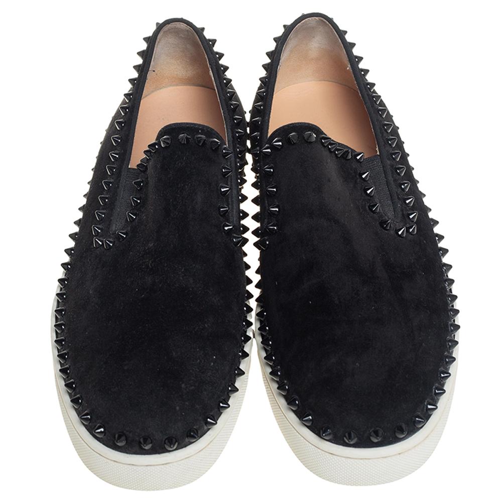 Make an amazing style statement in these slip-on sneakers from Christian Louboutin. They have been crafted from black suede and styled with round toes. They are adorned with multiple spike embellishments on the exterior and come equipped with
