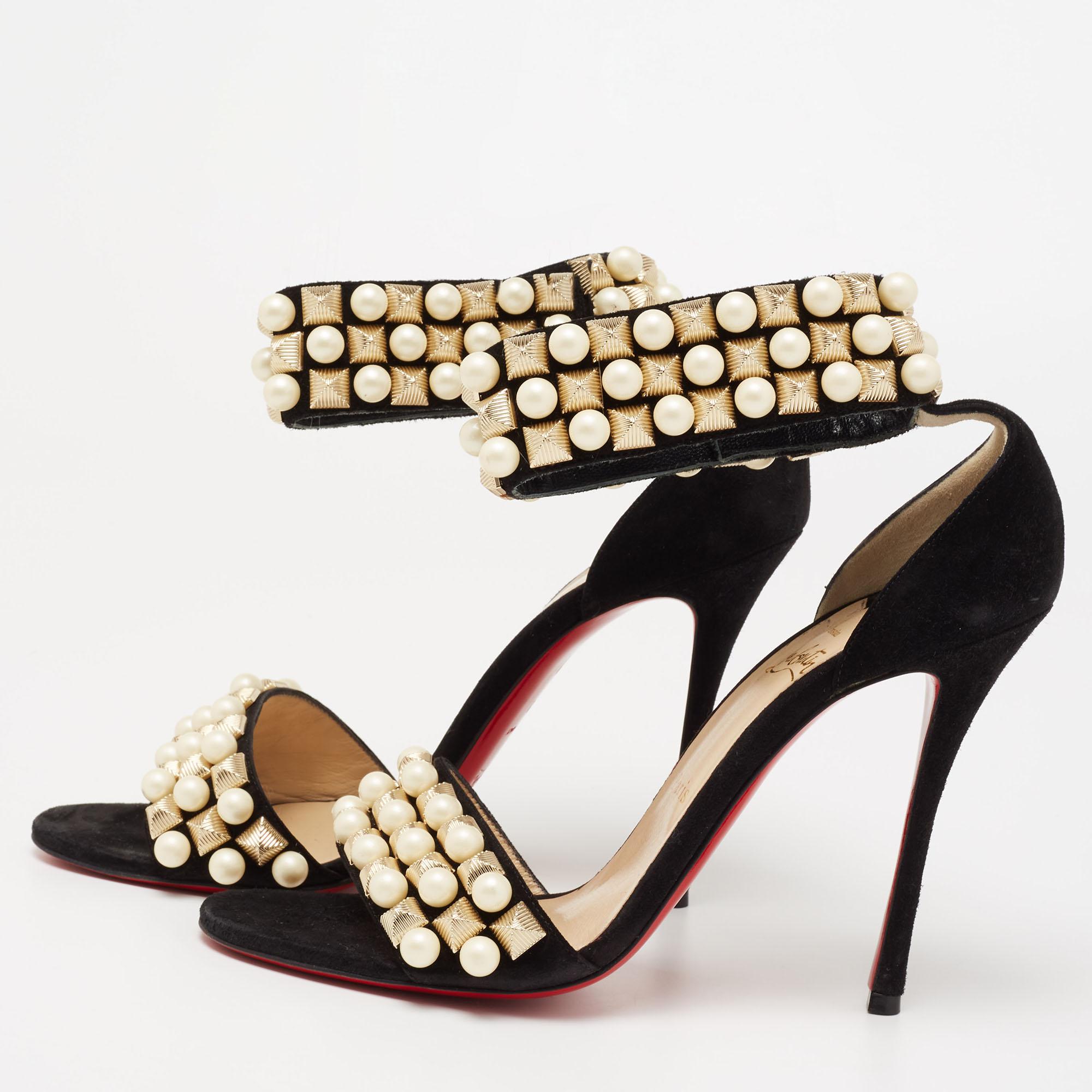 These Christian Louboutin sandals are a delightful creation. Made from suede, their vamps and ankle strap are beautifully decorated with faux pearls and embellishments. The signature red-lacquered sole of this pair signifies sophistication, and its