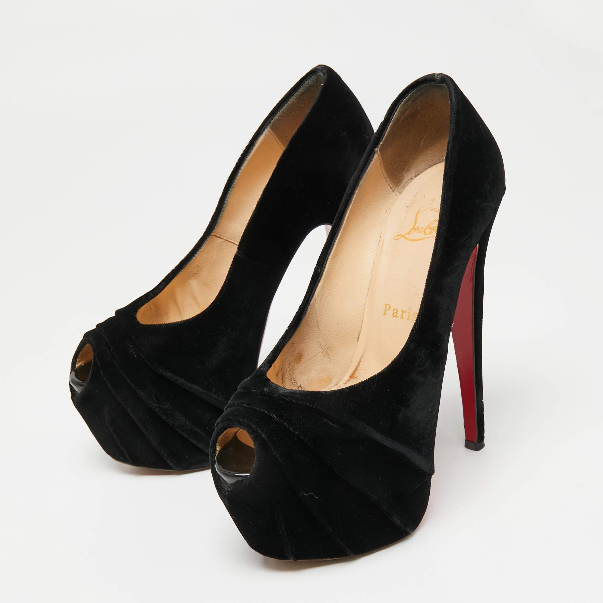 Made distinctive by the draped detailing on the vamps, these Christian Louboutins have been crafted from soft velvet. In addition to ultra-high heels, they have concealed platforms for extra support. The black pumps also feature peep-toes and are