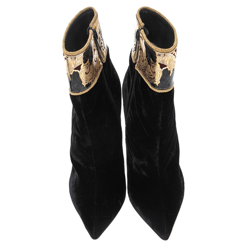 Christian Louboutin yet again brings a stunning set of boots that makes us marvel at its beauty and craftsmanship. Crafted from black velvet, the pointed toes enhance the look of your leg and the gold-tone embellishments add an opulent flair.

