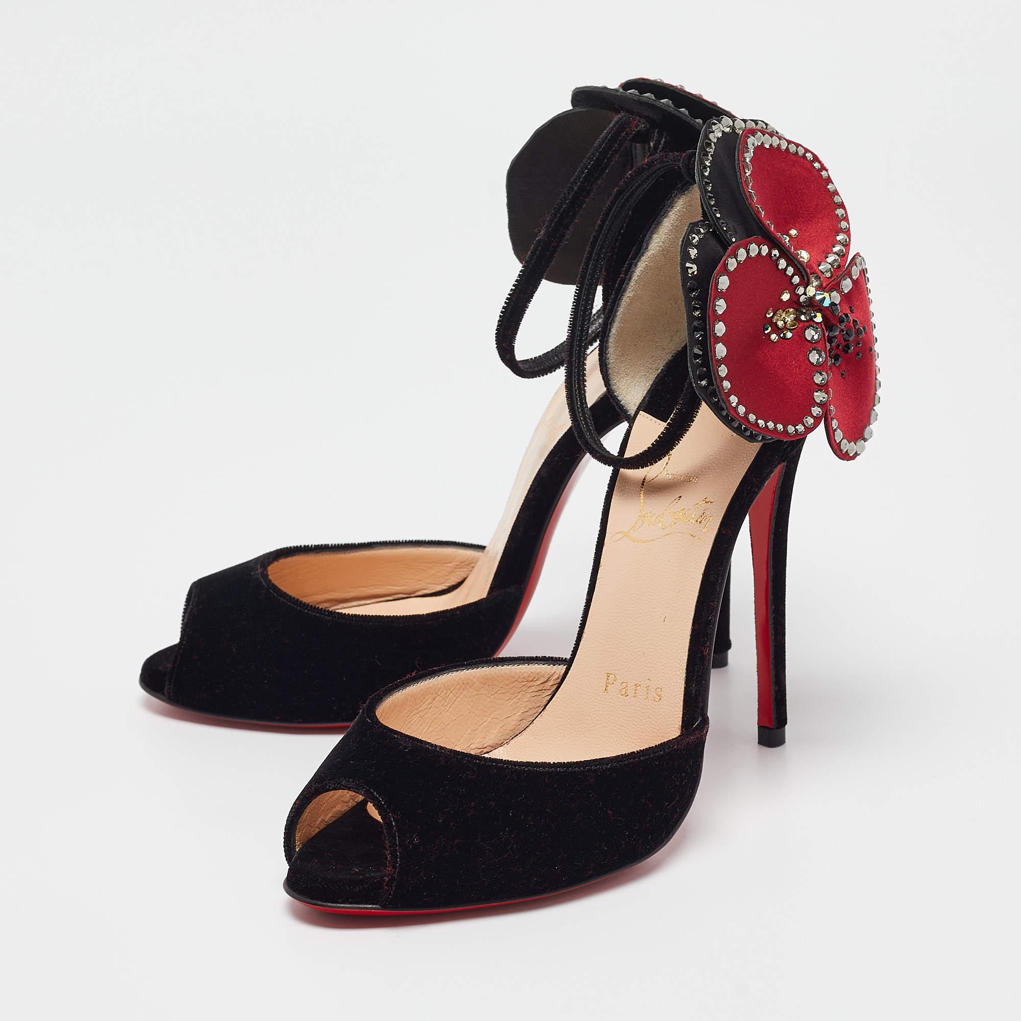 The Christian Louboutin Pensamoi sandals combine luxury and bold design with their striking velvet finish and signature red soles. Featuring an eye catching flower detail these sandals add a unique charm to any outfit. The sleek stiletto heel and