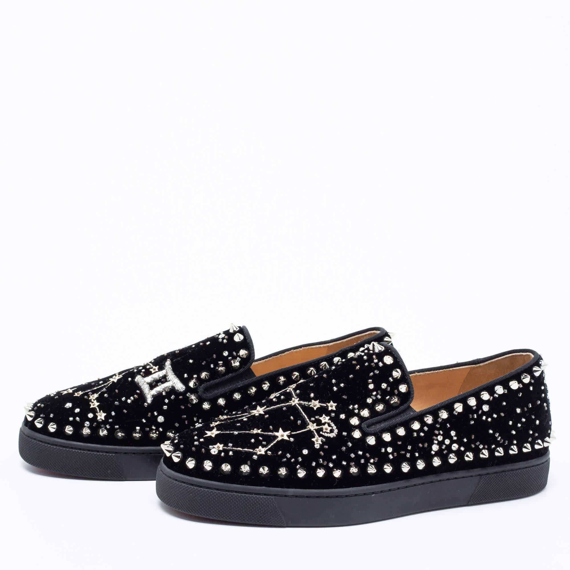 Beautifully crafted using black velvet, these Christian Louboutin slip-on sneakers are sure to keep you comfortably stylish. Featuring spikes and other embellishments on the uppers and flexible rubber soles in the iconic red, these shoes will be a
