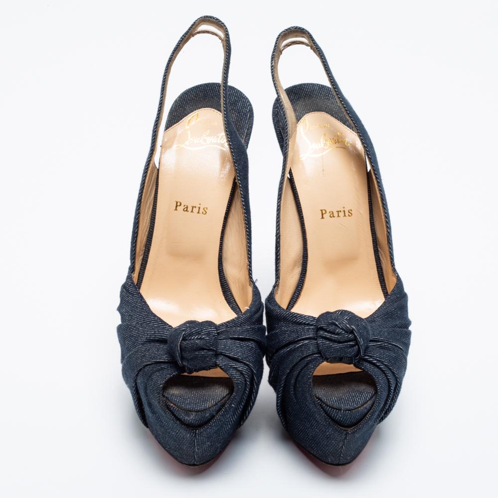 These sandals from Christian Louboutin embody the perfect blend of edgy and timeless style. Crafted from denim, they have a blue hue, knotted gathering over the toes, and a slingback closure. The 15.5cm heels and platforms will offer you the perfect