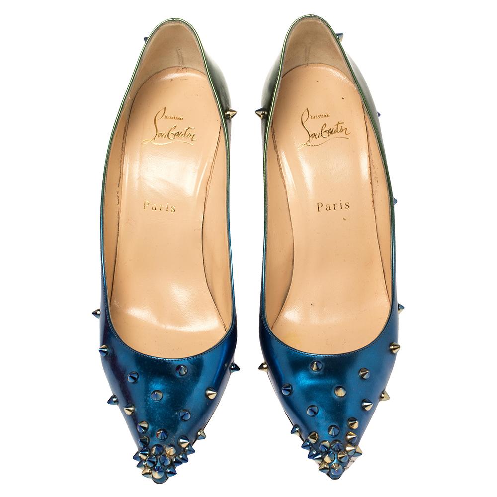 Be ready for constant compliments when you walk in these pumps from Christian Louboutin. Crafted from blue and green patent leather, they carry pointed toes and spikes decorated all over. The pair is complete with 10.5 cm heels, and the iconic red