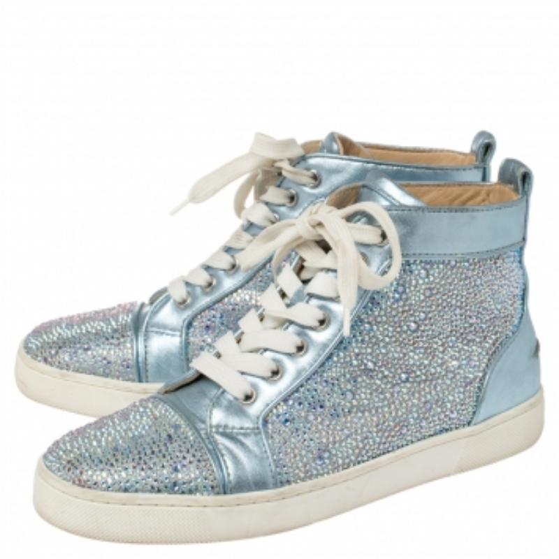 Outline effortless looks in these high-top sneakers from Christain Louboutin! They have been crafted from blue leather and styled with eye-catching embellishments on the exterior, round toes, lace-ups on the vamps, and pull tabs on the counters.