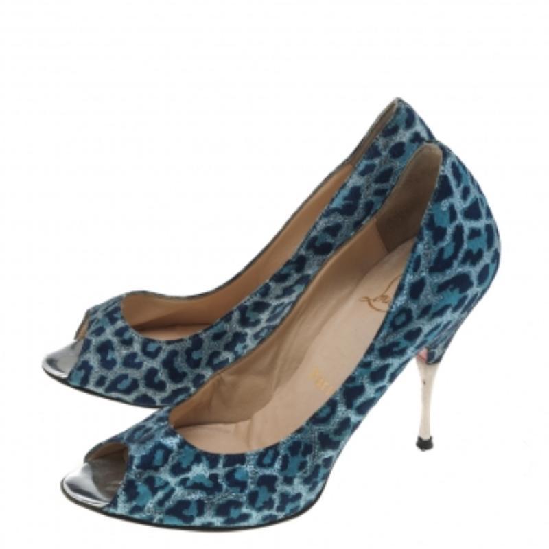 Designed by the House of Christian Louboutin, these stunning pumps will enhance your sense of fashion. They are crafted using blue leopard-printed fabric and feature peep-toes, a slip-on style, and pointy heels. Red soles beautify them more. Elevate