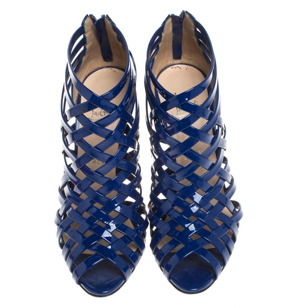 Gorgeously designed to make you look divine, these Christian Louboutin sandals are one of a kind! Classy in blue, these sandals are crafted from patent leather and feature a cage design. They flaunt zippers on the heel counters and come endowed with