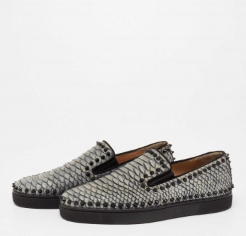Make an amazing style statement in these slip-on sneakers from Christian Louboutin. They have been crafted from python and styled with round toes. They are adorned with multiple spike embellishments on the exterior and come equipped with comfortable