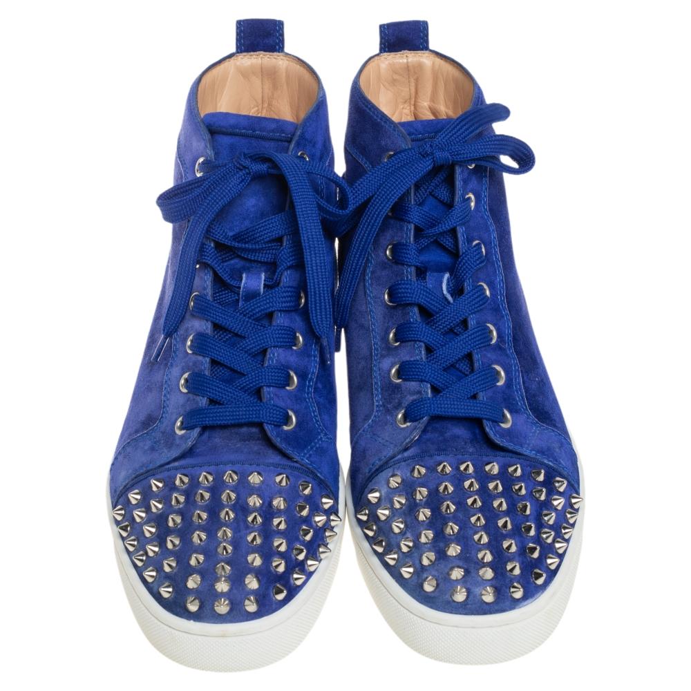We see the 'punk rock' aesthetic of Christian Louboutin well-translated on these sneakers. They are crafted from suede with spikes decorated on the cap toes. Lace-ups and leather insoles complete them. The red soles of the high-top sneakers will