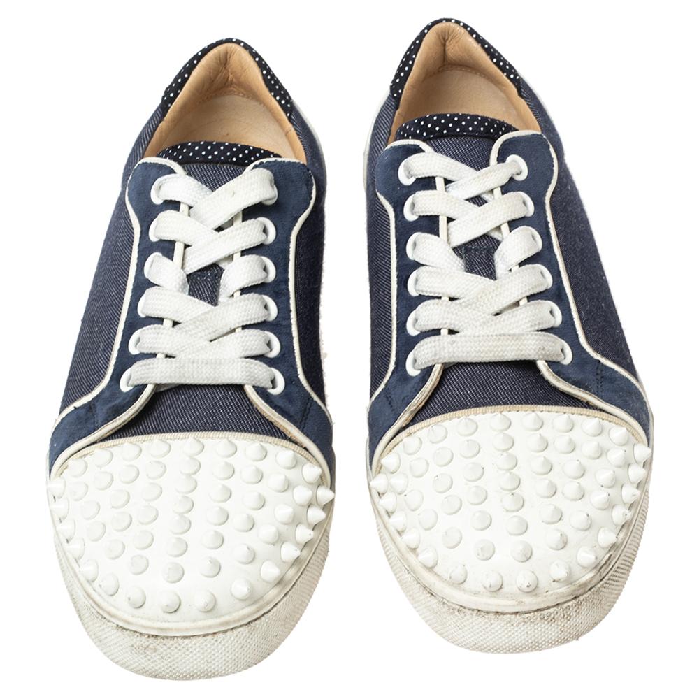 Christian Louboutin incorporates a statement look into these Vieira Spikes sneakers. They are crafted from blue-white denim and leather. To beautify their shape, they are adorned with spike embellishments on the toes and lace-up on the vamps. These