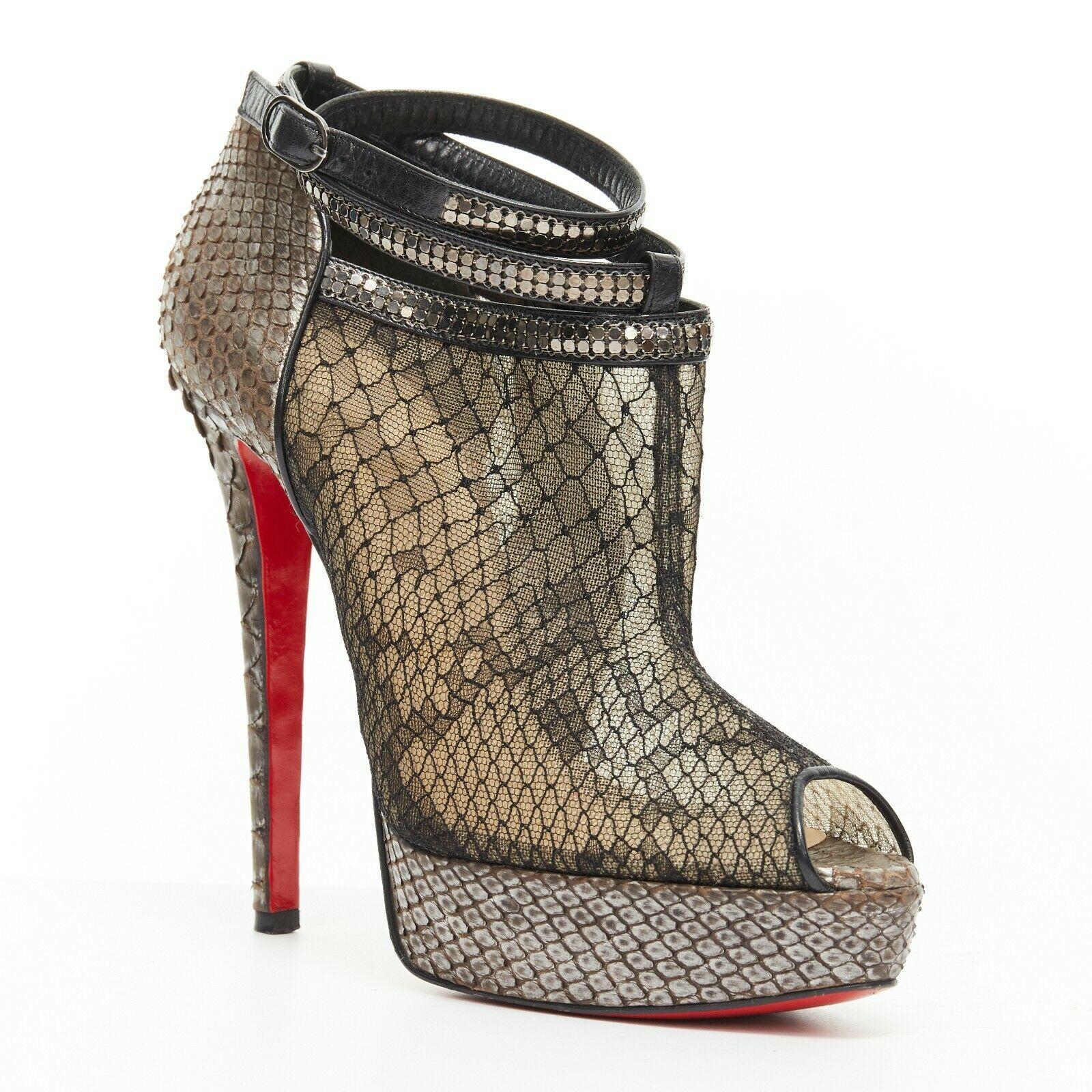 CHRISTIAN LOUBOUTIN Brigette 140 black mesh lace python platform bootie EU38
CHRISTIAN LOUBOUTIN
Brigette 140. 
Black python scale mesb lace upper. 
Peep toe. 
Genuine scaled python wrapped platform and heel. 
Black leather trimming. 
Wrap around