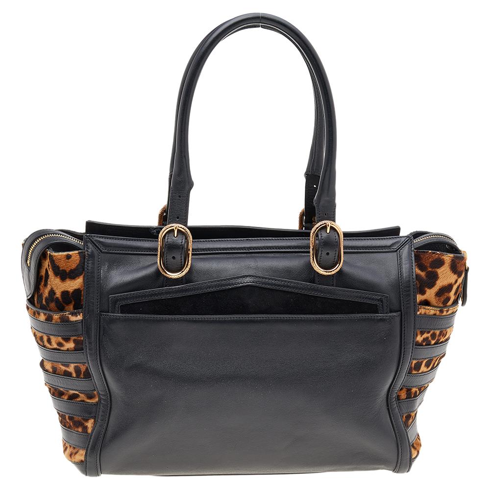 Made from leopard-printed calf hair and black leather, this Christian Louboutin satchel brings a convenient size and a refined appeal. It features two handles, gold-tone hardware, and a fabric-lined interior.

