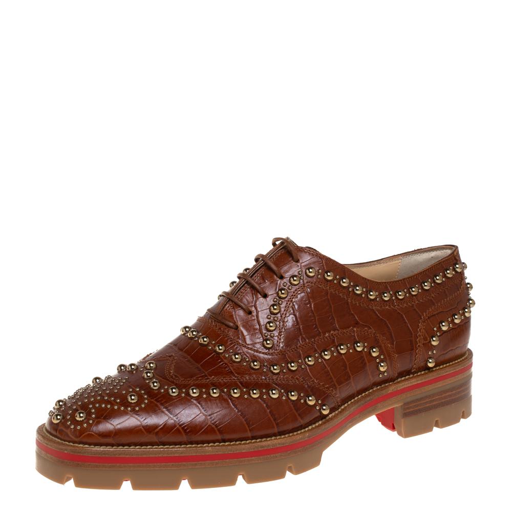 Oxfords are always in vogue and this pair from Christian Louboutin proves that with its fabulous design and craftsmanship. The classy brown oxfords are crafted from croc-embossed leather and adorned with gold-tone studs. They are styled with