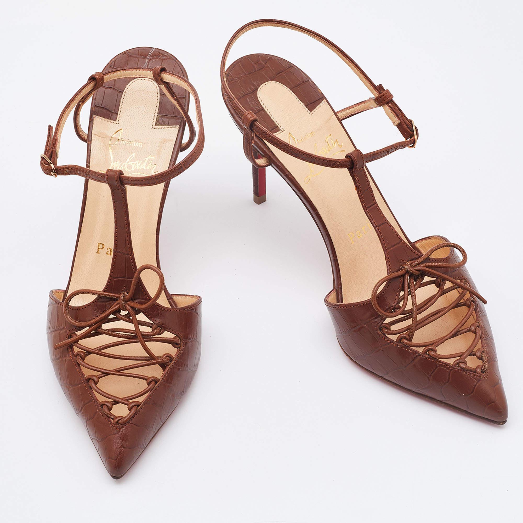 Make an elegant style statement with these classic ankle-strap pumps from Christian Louboutin. The croc-embossed leather pair flaunts a simple yet chic design and is finished neatly with buckle closures and comfortable leather