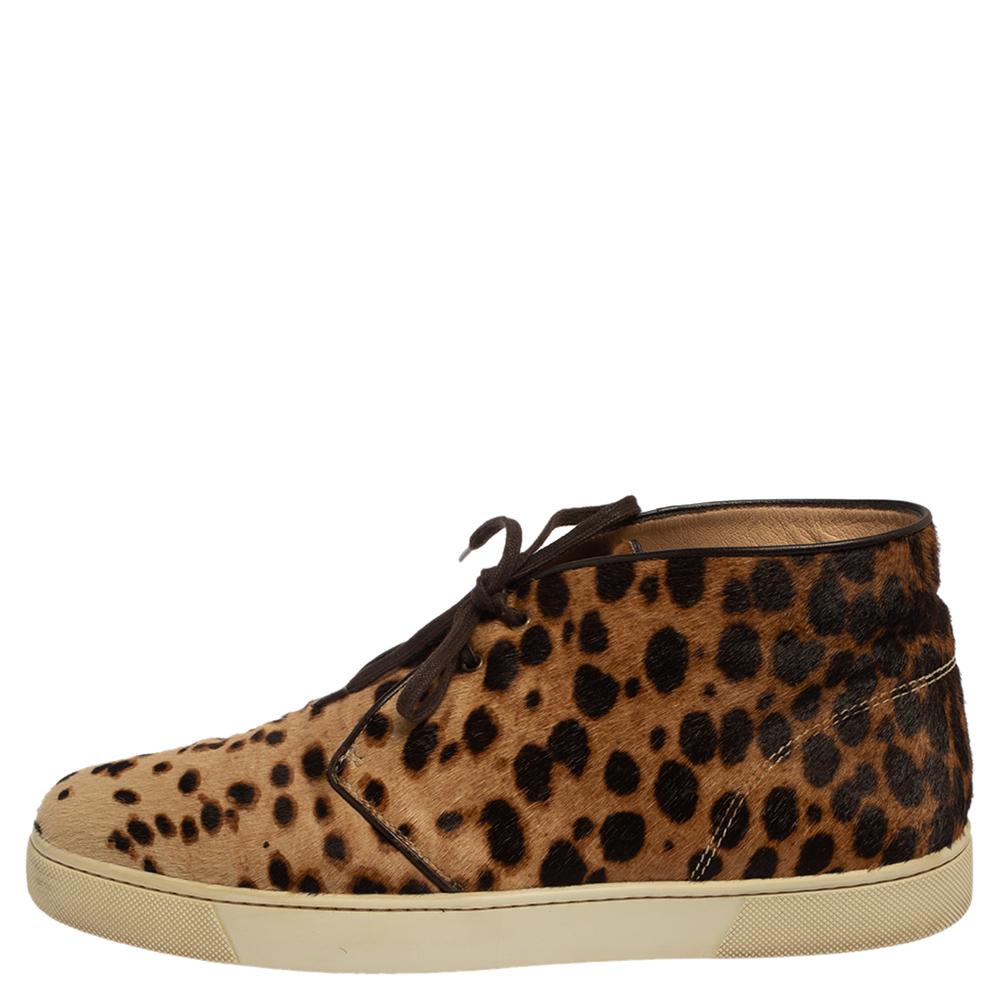 Pull off a stylish look with class in this pair of stylish sneakers from Christian Louboutin. Crafted from leopard-printed calf hair, this pair truly embodies luxury and comfort. The brown-hued sneakers feature lace-ups, leather insoles, and red