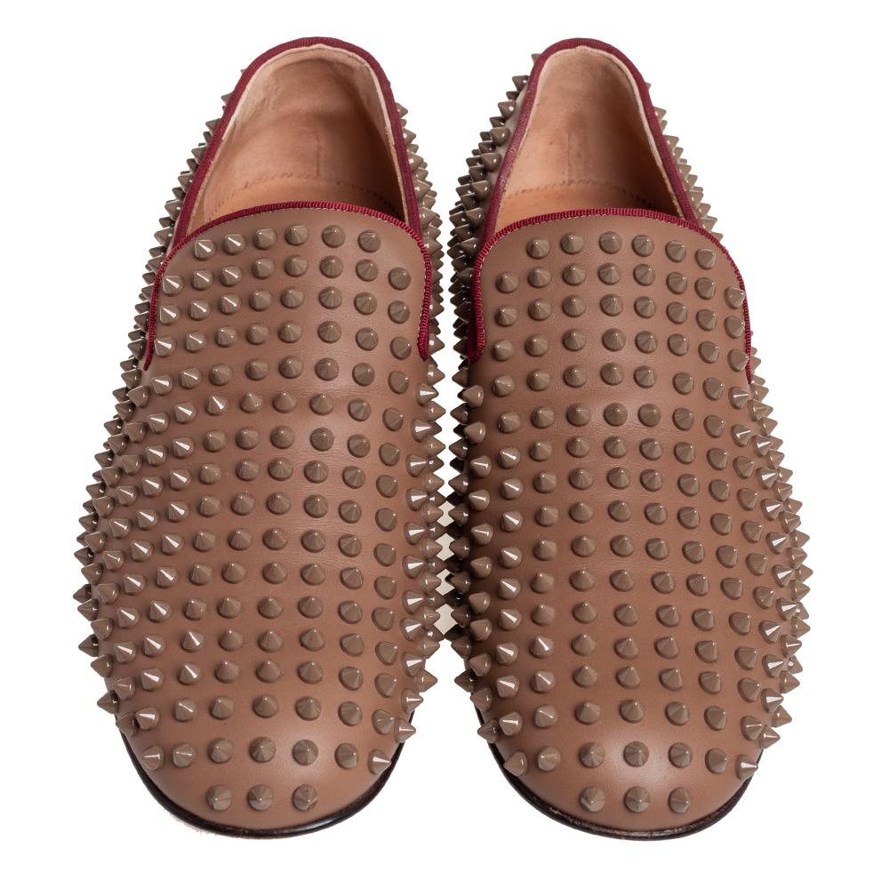 Crafted from brown leather, these smoking slippers from Christian Louboutin simply stand out! They feature a round-toe silhouette with the signature spike embellishments adorning the exterior. They are complete with comfortable leather-lined insoles