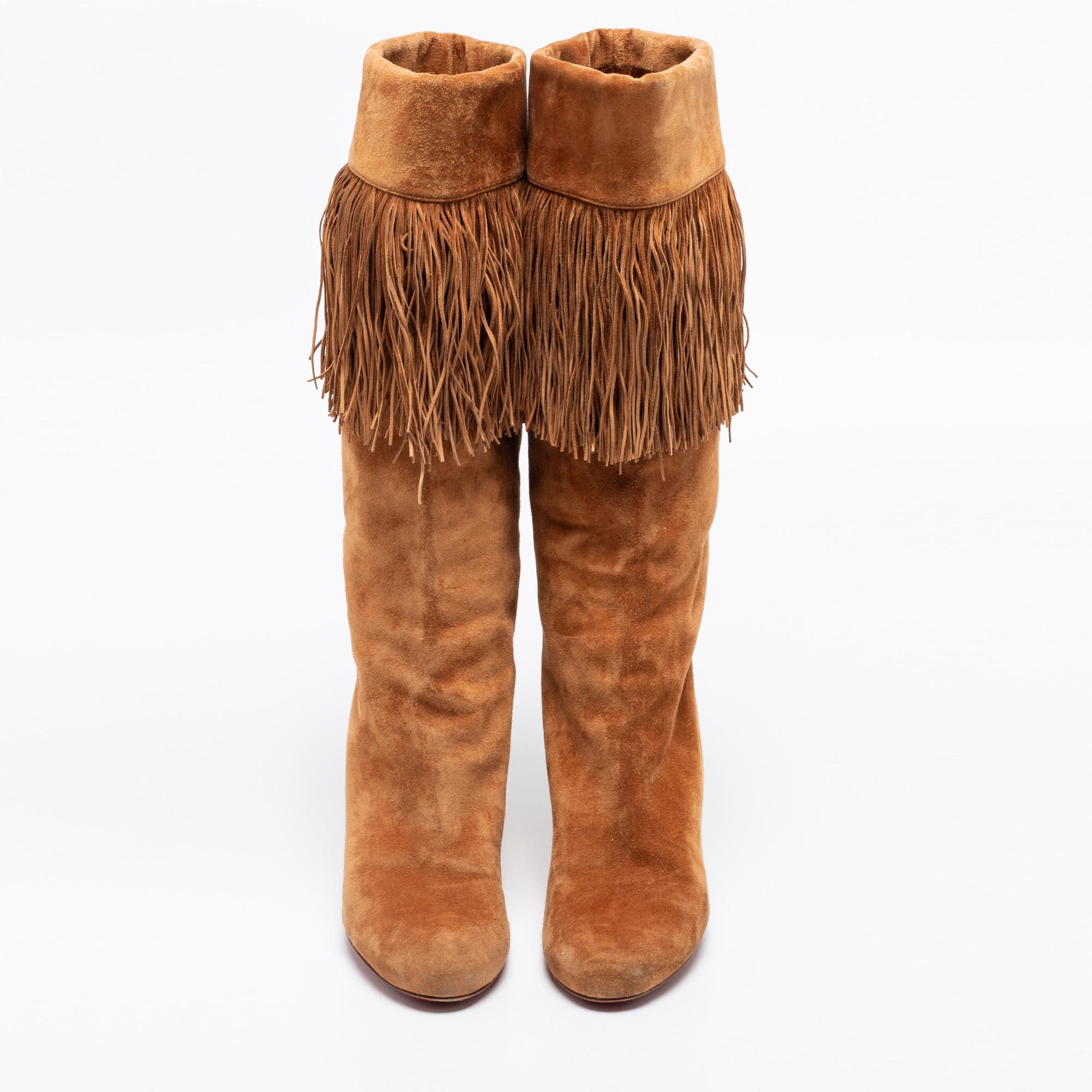 Opt for these brown mid-calf boots from Christian Louboutin if you're willing to take a step ahead and upgrade your fashion quotient. Crafted from suede, they feature fabulous fringe details and 9 cm heels. Rounded toes and comfortable leather