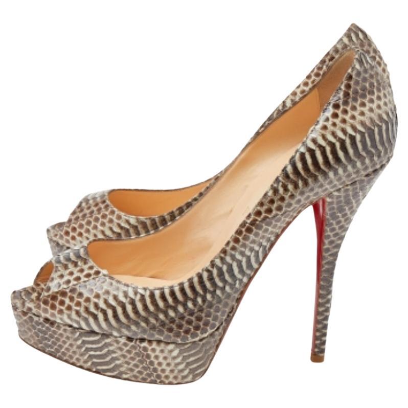 Stand out from the crowd with this gorgeous pair of Louboutins that exude high fashion with class! Crafted from snakeskin, this is a creation from their Lady Peep collection. They feature a classic brown shade with peep toes and a glossy exterior.