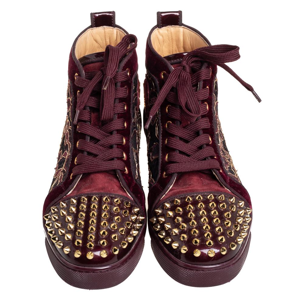 We can't help but wonder how Christian Louboutin creates beautiful footwear like these sneakers every time! Crafted from patent leather and velvet, these sneakers are adorned with spikes and floral motifs. Finished off with laces and round toes,