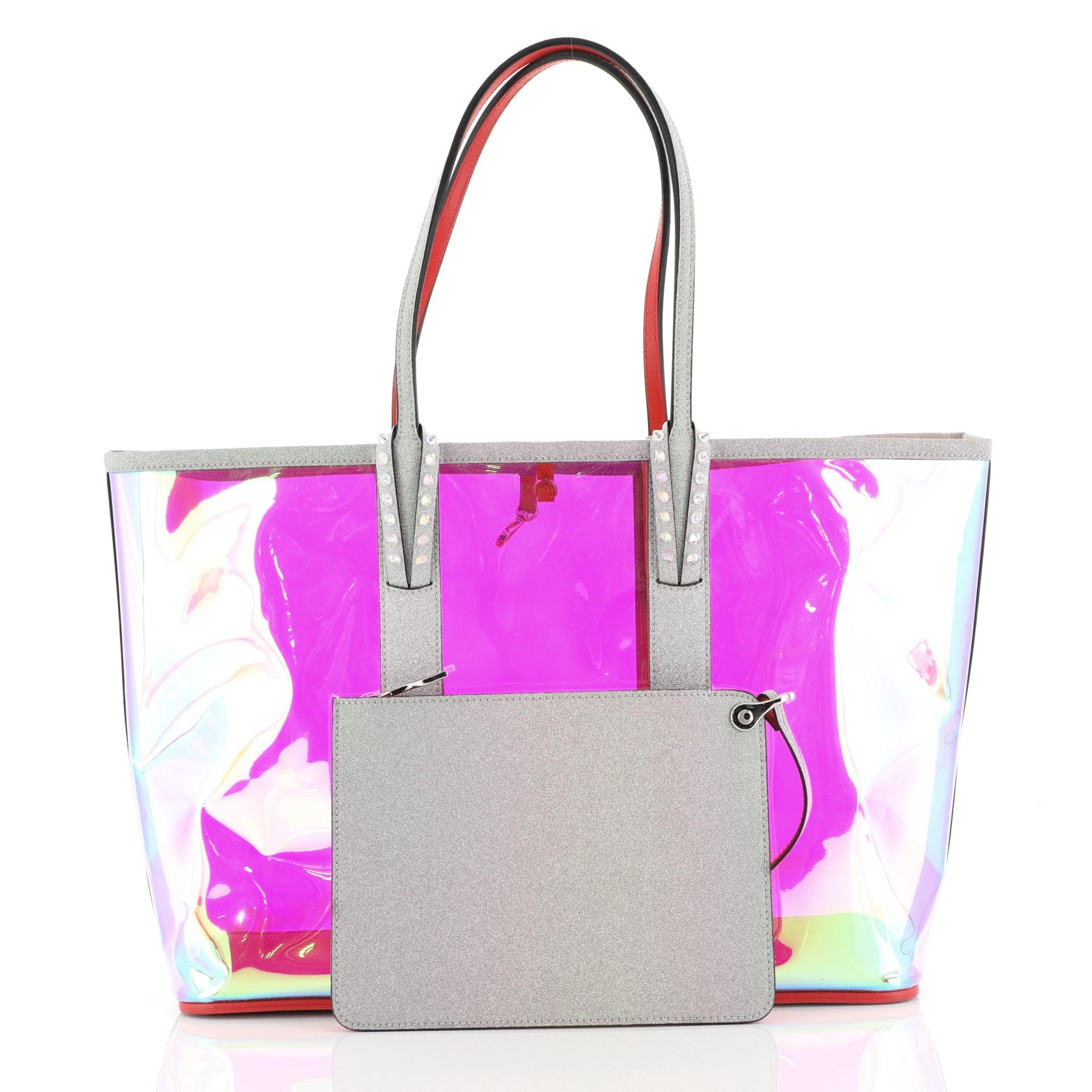 This Christian Louboutin Cabata East West Tote PVC Large, crafted in multicolor and clear PVC, features flat leather shoulder strap with studded loops and silver-tone hardware. It opens to a clear PVC interior. 

Estimated Retail Price: