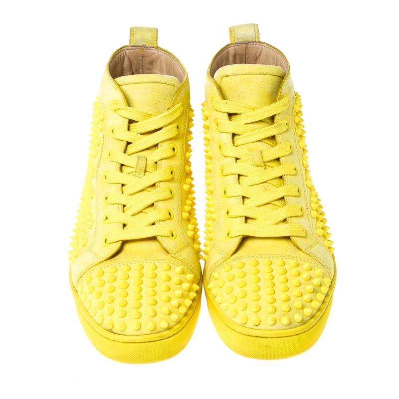 Feel great in your casual wear every time you step out in these sneakers from Christian Louboutin. They have been crafted from suede and styled as a high top with an exterior detailed with spikes. The sneakers carry round toes, lace-up vamps, and