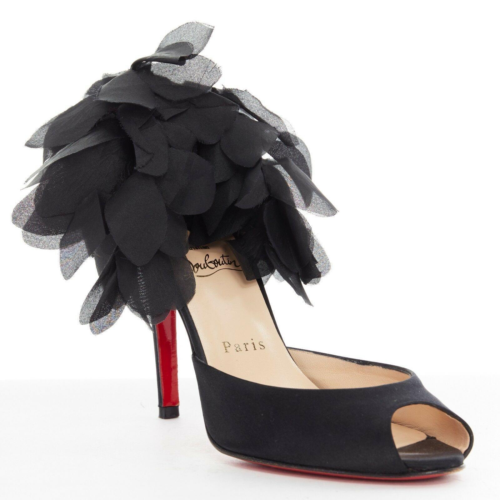 CHRISTIAN LOUBOUTIN Carnival 100 black satin peep toe ruffle petal heel EU37.5
CHRISTIAN LOUBOUTIN
Carnival 100. 
Black satin upper. Peep toe. Ruffle petal at heel. High heel. 
Padded tan leather lining. Signature red Louboutin lacquared sole. 
Made