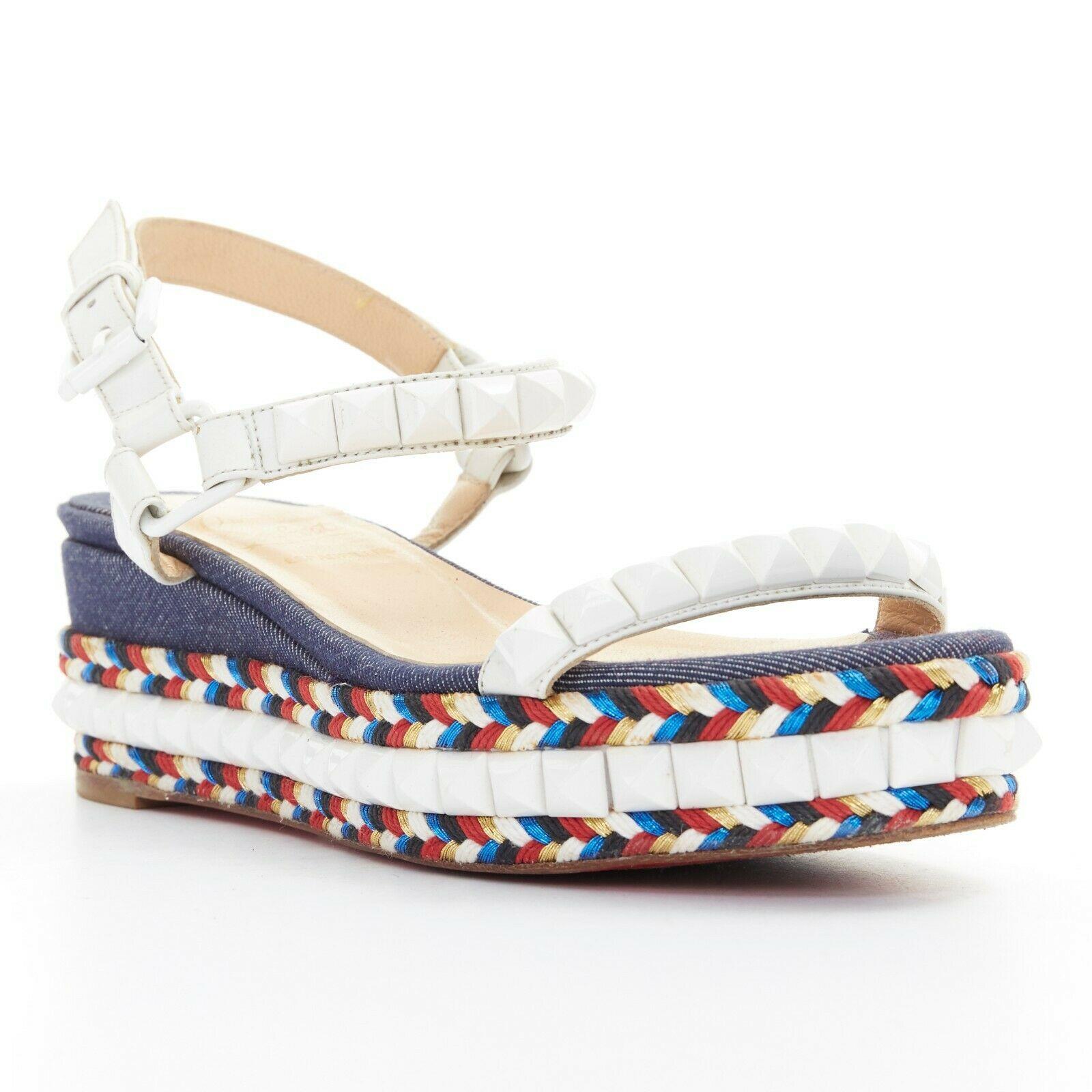 CHRISTIAN LOUBOUTIN Cataclou embroidery white spike stud platform sandal EU35
CHRISTIAN LOUBOUTIN
Cataclou sandals. Blue denim covered sole. Multicolor tribal embroidery trimming. 
White pyramid spike stud trimming along outsole. White leather stud