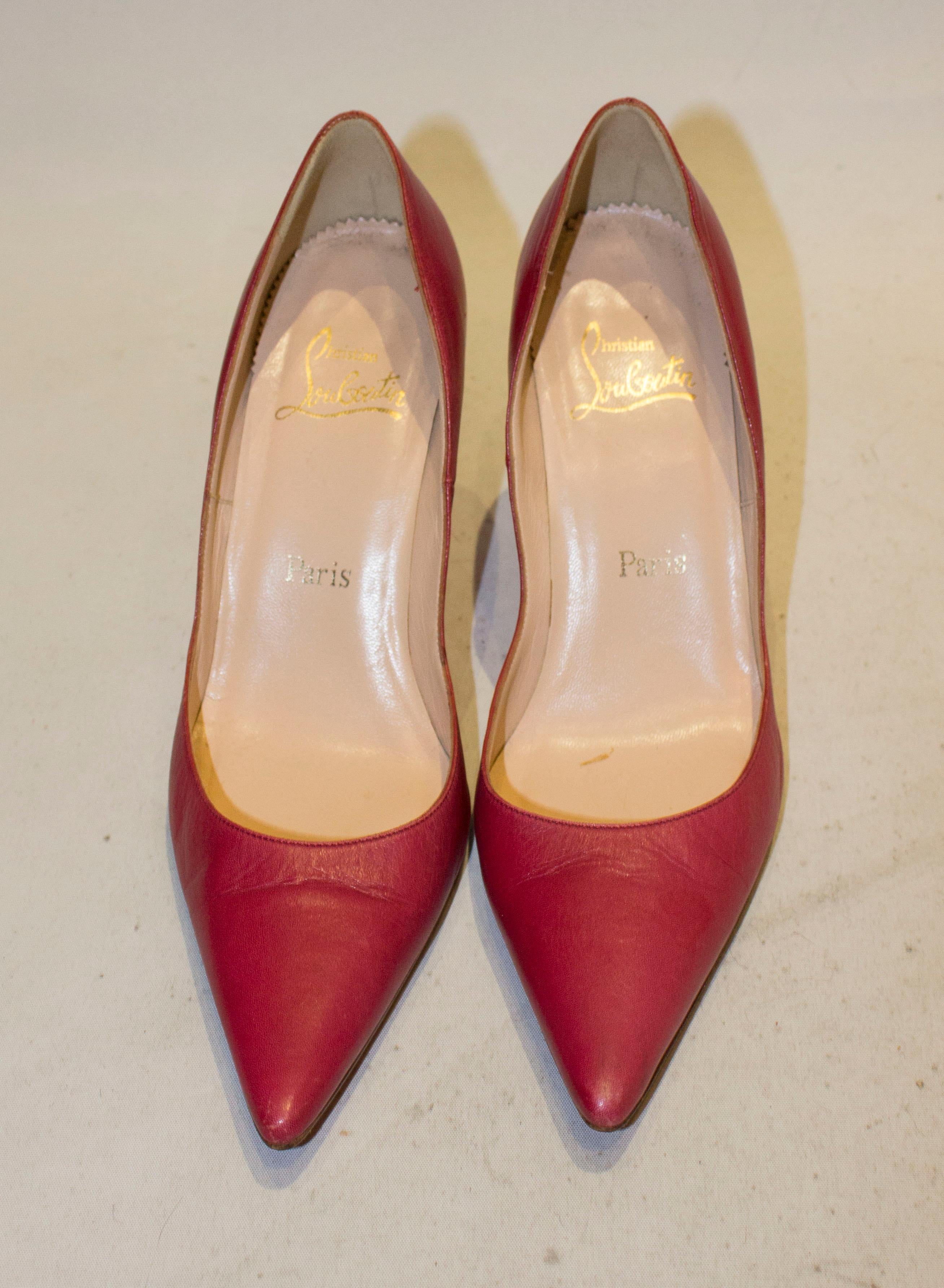 A fun pair of cerise pink leather heels by Christian Louboutin The shoes have stilleto heels, are leather lined and size 38 1/2 with a 4'' heel.
